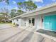 Charming single-story home with a welcoming front porch and a modern, vibrant blue front door at 8693 15Th N St, St Petersburg, FL 33702