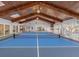 Bright game room boasts high ceilings with skylights, a pickleball court, and views of the outdoor living area at 8693 15Th N St, St Petersburg, FL 33702