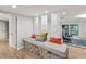 Interior hallway featuring decorative columns, a built-in bench with stone accents, and views of the living space at 8693 15Th N St, St Petersburg, FL 33702