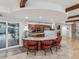 Kitchen layout featuring island with stools and view of the swimming pool at 8693 15Th N St, St Petersburg, FL 33702