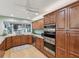Modern kitchen featuring stainless steel appliances, wooden cabinets, and granite countertops at 8693 15Th N St, St Petersburg, FL 33702
