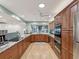 Spacious kitchen featuring wood cabinets, granite countertops, modern appliances, and ample natural light at 8693 15Th N St, St Petersburg, FL 33702