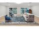 Comfortable living room showcases access to the indoor pool, plush seating, and an elegant crystal chandelier at 8693 15Th N St, St Petersburg, FL 33702