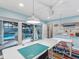Spacious office with tables and sliding glass doors looking out to the pool at 8693 15Th N St, St Petersburg, FL 33702