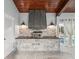This outdoor kitchen features stone accents, a built-in pizza oven, and access to the home's outdoor living spaces at 8693 15Th N St, St Petersburg, FL 33702