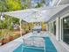 Enjoy this serene outdoor patio with upscale patio furniture, a large umbrella, and access to the hot tub at 8693 15Th N St, St Petersburg, FL 33702