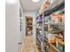 Walk-in pantry features wood look flooring and metal shelving providing ample storage space at 8693 15Th N St, St Petersburg, FL 33702