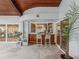 Outdoor patio wet bar area featuring wood bar, stone flooring, and sliding glass doors at 8693 15Th N St, St Petersburg, FL 33702