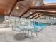 Indoor pool and hot tub area with wood ceilings, a sitting area, and lovely views of the garden at 8693 15Th N St, St Petersburg, FL 33702