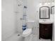 Bathroom with shower, white toilet, and dark wood vanity at 9031 Westchester Cir # 126, Tampa, FL 33604