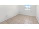 Well-lit bedroom showcasing tile flooring, and a window at 9031 Westchester Cir # 126, Tampa, FL 33604