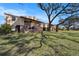 Apartment building with brick accents, wooden staircases, and beautiful lawn at 9031 Westchester Cir # 126, Tampa, FL 33604