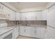 A well-lit kitchen with white cabinets, stainless steel appliances, and granite countertops at 9031 Westchester Cir # 126, Tampa, FL 33604