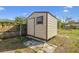 View of backyard shed with aluminum siding, small window and close to a wooden fence at 10201 N Ninevah Rd, Tampa, FL 33617