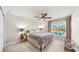 Bedroom with a ceiling fan, large window, and a view of the pool at 10209 Spanish Breeze Ct, Riverview, FL 33578