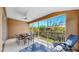 Screened lanai with ceiling fan, outdoor furniture and view of lush greenery at 10209 Spanish Breeze Ct, Riverview, FL 33578