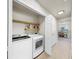Laundry room featuring a washer, dryer, and shelving for storage at 10209 Spanish Breeze Ct, Riverview, FL 33578