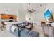 Open-concept living room with neutral tones, a plush sofa, and an adjacent kitchen area at 10209 Spanish Breeze Ct, Riverview, FL 33578