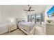 Bright main bedroom featuring a large window, ceiling fan, and neutral decor at 10209 Spanish Breeze Ct, Riverview, FL 33578