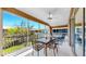 Relaxing screened-in patio furnished with a dining set, offering a tranquil outdoor living space at 10209 Spanish Breeze Ct, Riverview, FL 33578