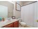 Cozy bathroom featuring a framed mirror and shower with white shower curtain at 10623 Pearl Berry Loop, Land O Lakes, FL 34638