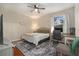 Comfortable bedroom featuring a ceiling fan, desk area, and natural light at 10623 Pearl Berry Loop, Land O Lakes, FL 34638