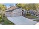 Charming home with a three-car garage, well-manicured landscaping, and inviting curb appeal at 10623 Pearl Berry Loop, Land O Lakes, FL 34638
