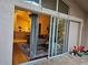 Living room and kitchen view from the outside patio through sliding glass doors at 10623 Pearl Berry Loop, Land O Lakes, FL 34638