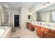 Spacious main bathroom offering a double vanity, soaking tub, and separate glass shower at 10623 Pearl Berry Loop, Land O Lakes, FL 34638