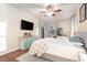 Bright main bedroom featuring a ceiling fan, stylish dresser, and private outdoor access at 10623 Pearl Berry Loop, Land O Lakes, FL 34638