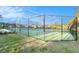 Outdoor tennis court with fence surround and view of the community homes at 10623 Pearl Berry Loop, Land O Lakes, FL 34638