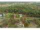 Aerial view showcasing a house with red property lines amidst a rural backdrop at 1126 Oxbow Rd, Wimauma, FL 33598