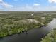 Beautiful riverfront property boasts a private dock, enhancing its waterfront appeal, and is surrounded by lush vegetation at 1126 Oxbow Rd, Wimauma, FL 33598
