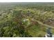 Aerial view of property with mature trees, large lot, and charming home, property lines shown at 1126 Oxbow Rd, Wimauma, FL 33598