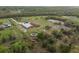 Wide-open horse property features barns, paddocks, riding circle and pastures, all surrounded by natural landscaping at 1126 Oxbow Rd, Wimauma, FL 33598