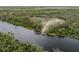 Scenic riverfront estate featuring a private dock and tranquil surroundings offers an idyllic setting for nature lovers and outdoor enthusiasts at 1126 Oxbow Rd, Wimauma, FL 33598