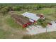 Farm featuring barns, paddocks, and an expansive tree-lined pasture at 1126 Oxbow Rd, Wimauma, FL 33598