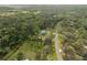 Beautiful aerial view of wooded acreage and charming home on large lot with mature trees at 1126 Oxbow Rd, Wimauma, FL 33598
