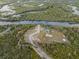 Overhead view of Florida riverfront acreage featuring dock, picnic area, and surrounding greenery at 1126 Oxbow Rd, Wimauma, FL 33598