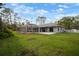 Expansive backyard with screened lanai and lush landscaping, perfect for outdoor entertaining at 1126 Oxbow Rd, Wimauma, FL 33598