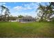 Sprawling backyard features a screened pool, lush lawn, and a storage shed, perfect for outdoor enjoyment at 1126 Oxbow Rd, Wimauma, FL 33598