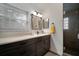 Bathroom featuring a modern vanity with double sinks and a glass-enclosed shower at 1126 Oxbow Rd, Wimauma, FL 33598