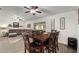 Open-concept dining area features a wood table with seating for six, adjacent to a living room with a large sectional sofa at 1126 Oxbow Rd, Wimauma, FL 33598