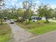 Spacious home with an extra long driveway, large yard, and ample parking space at 1126 Oxbow Rd, Wimauma, FL 33598