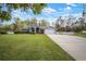 Inviting single-story home with a well-maintained lawn and classic white picket fence on a beautiful, sunny day at 1126 Oxbow Rd, Wimauma, FL 33598