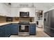 Well-equipped kitchen with stainless steel appliances and a view of the laundry room at 1126 Oxbow Rd, Wimauma, FL 33598