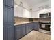 Modern kitchen with stainless steel oven and microwave, two-tone cabinets, and wood-look flooring at 1126 Oxbow Rd, Wimauma, FL 33598