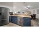 Bright kitchen featuring stainless steel refrigerator, and open view to dining and living areas at 1126 Oxbow Rd, Wimauma, FL 33598