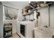 Laundry room with washer, dryer, utility sink, and shelving at 1126 Oxbow Rd, Wimauma, FL 33598