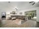 Open-concept living room featuring a large sectional sofa and screened patio access at 1126 Oxbow Rd, Wimauma, FL 33598